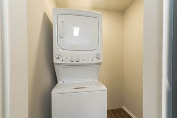 An empty laundry room with a washer and dryer